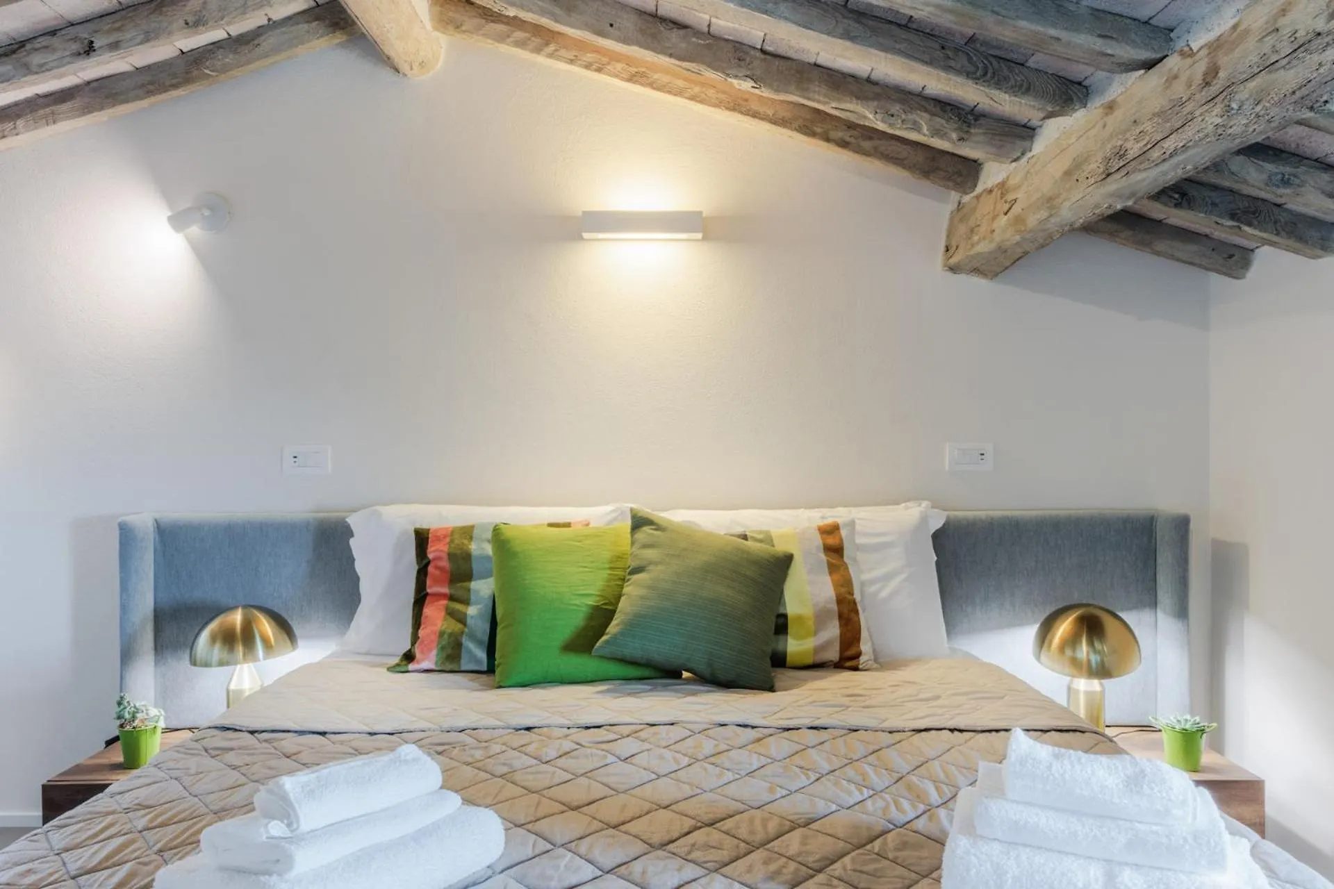 A bedroom at Villa Gioma with a king bed under the beams