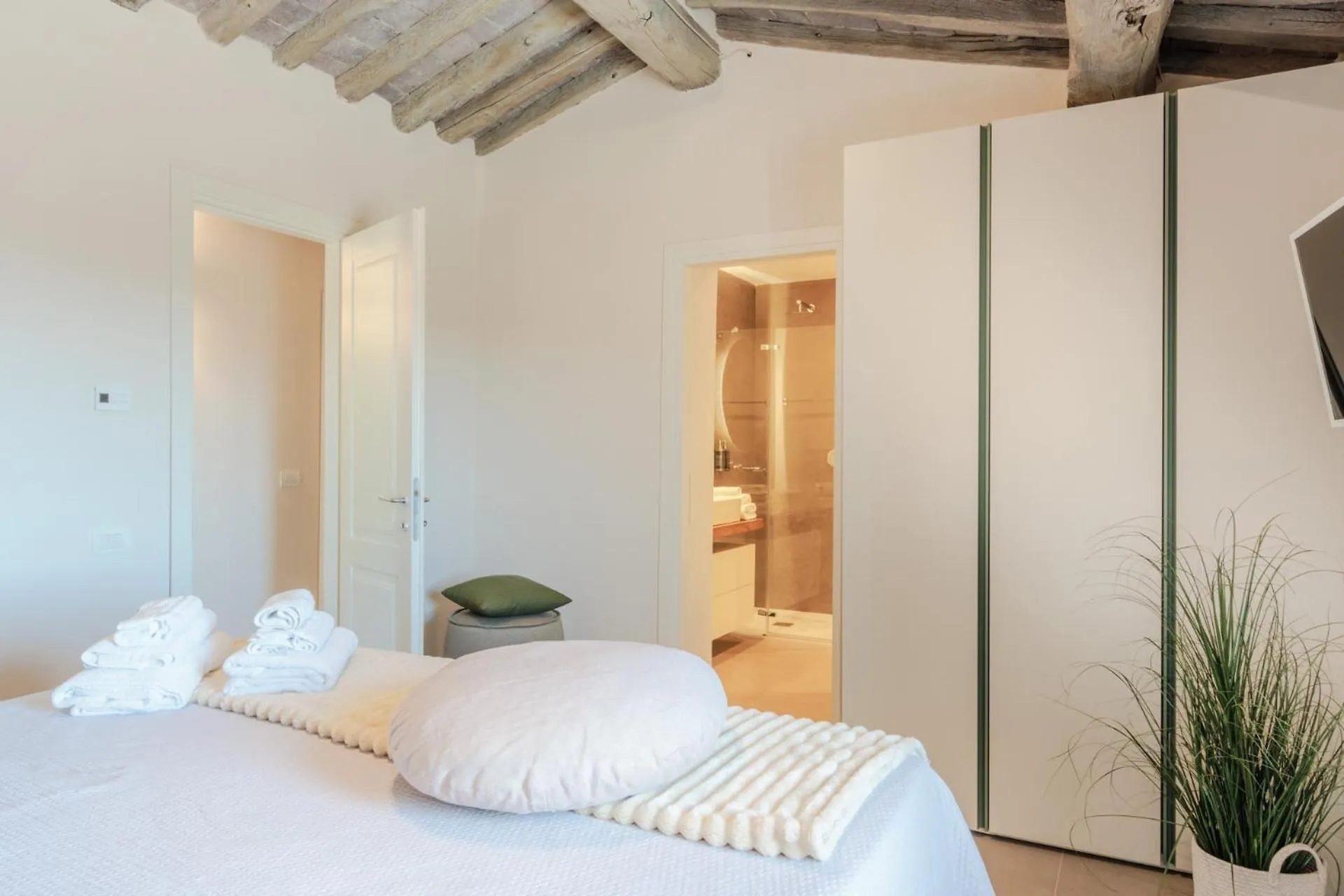 A bedroom at Villa Gioma with a king bed under the beams