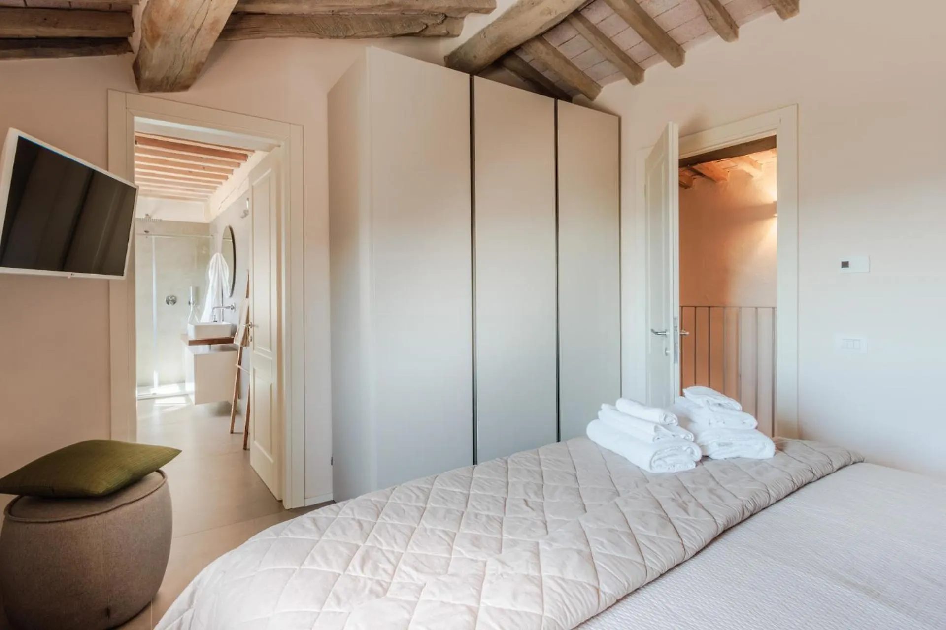 A bedroom at Villa Gioma with a king bed under the beams