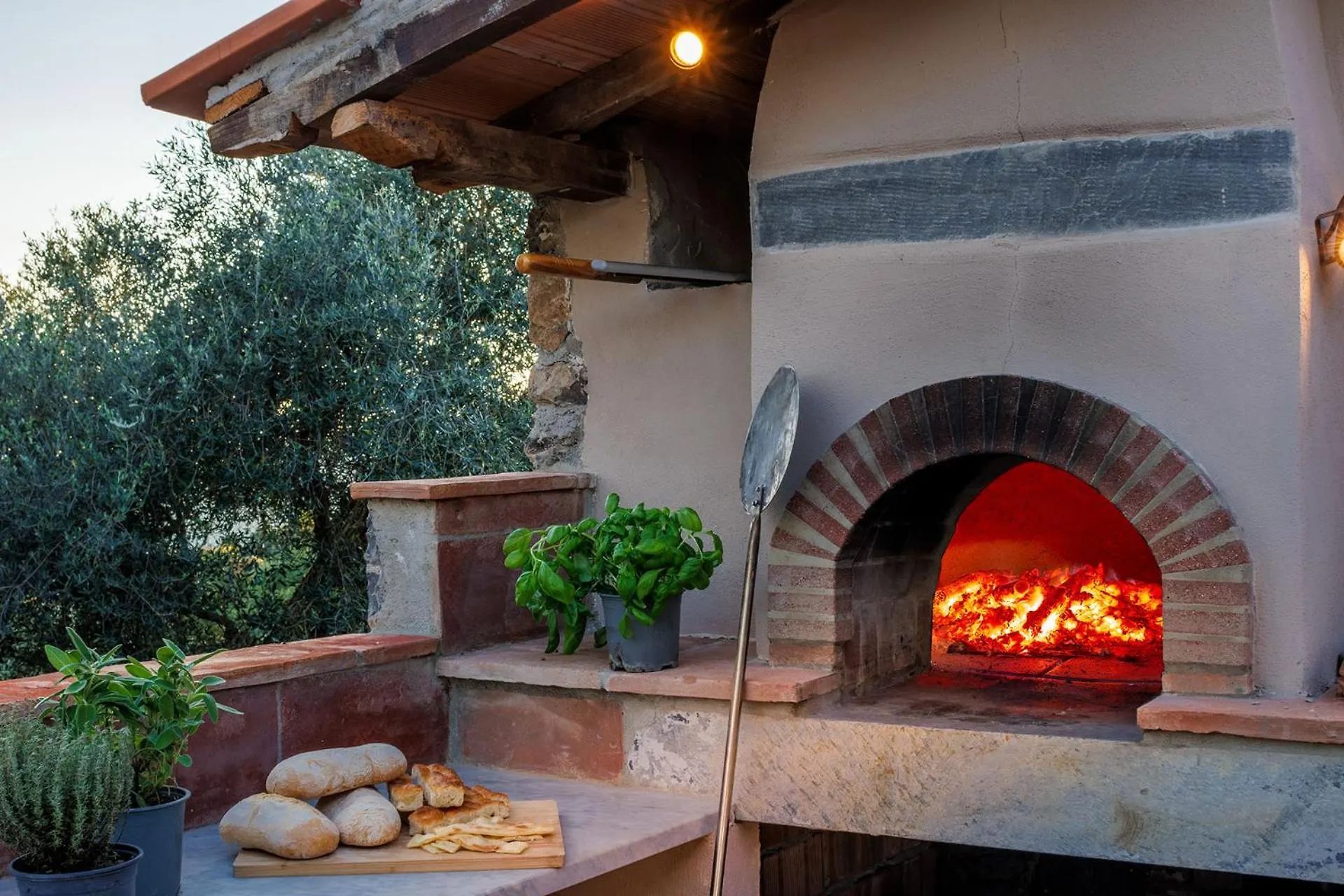 The wood-fired oven lit on the patio at Villa Gioma