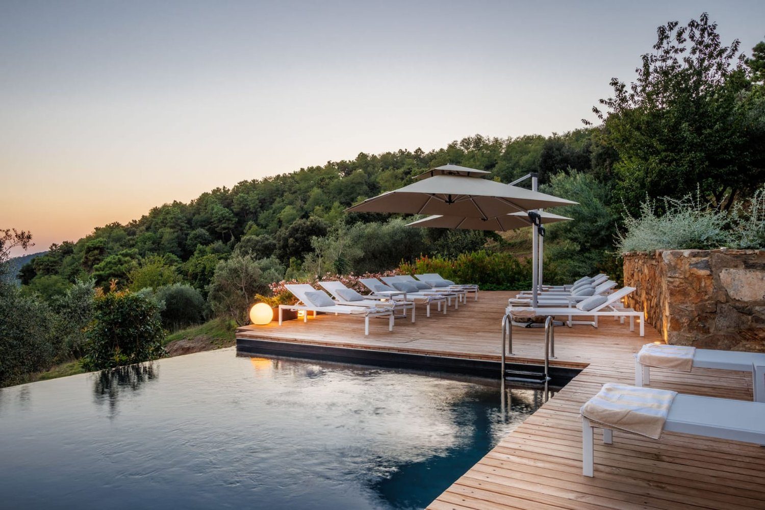 Villa Gioma from outside: the stone farmhouse and the terrace over the hills of Lucca