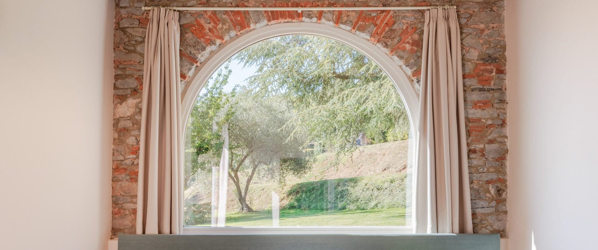 Villa Gioma from outside: the stone farmhouse and the terrace over the hills of Lucca