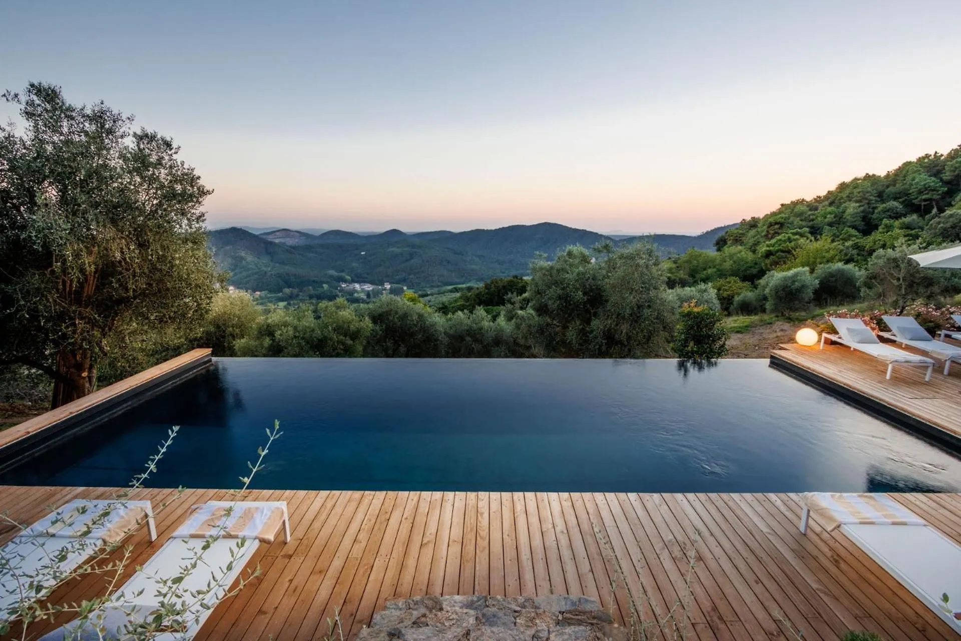 The infinity pool at Villa Gioma with the view over the hills at sunset