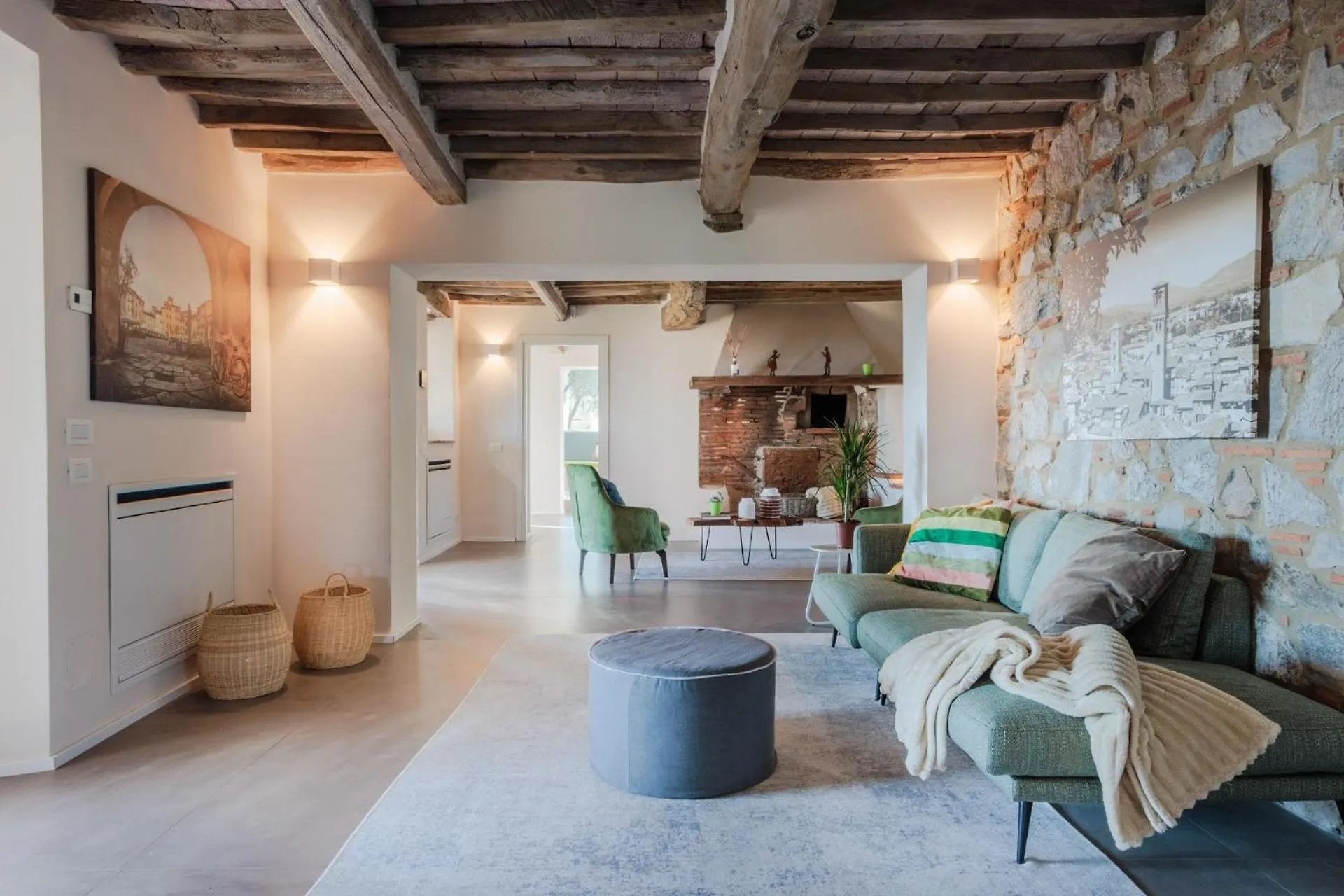 The living room at Villa Gioma with exposed beams and stone fireplace